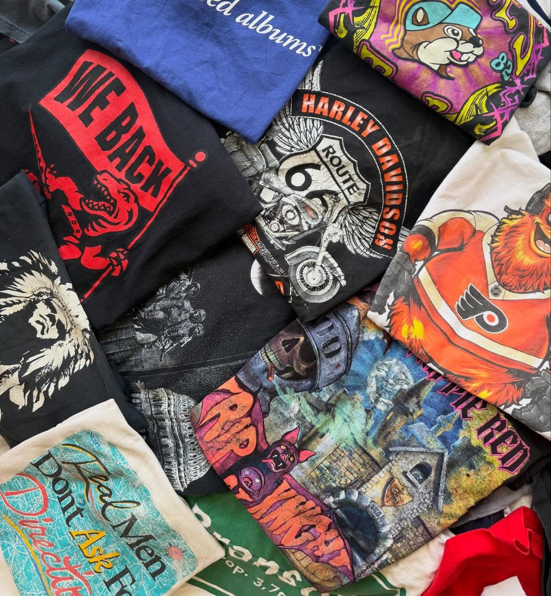 Spread of vintage graphic tees including Harley-Davidson, Route 66, and band tees at Prime Rewind