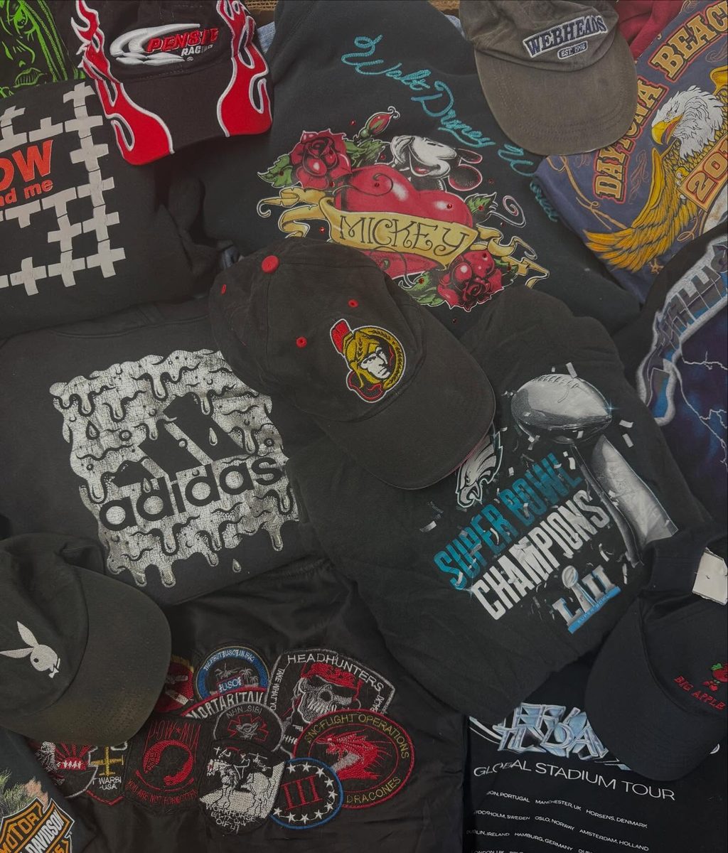 Flat lay of vintage caps, branded tees, and accessories